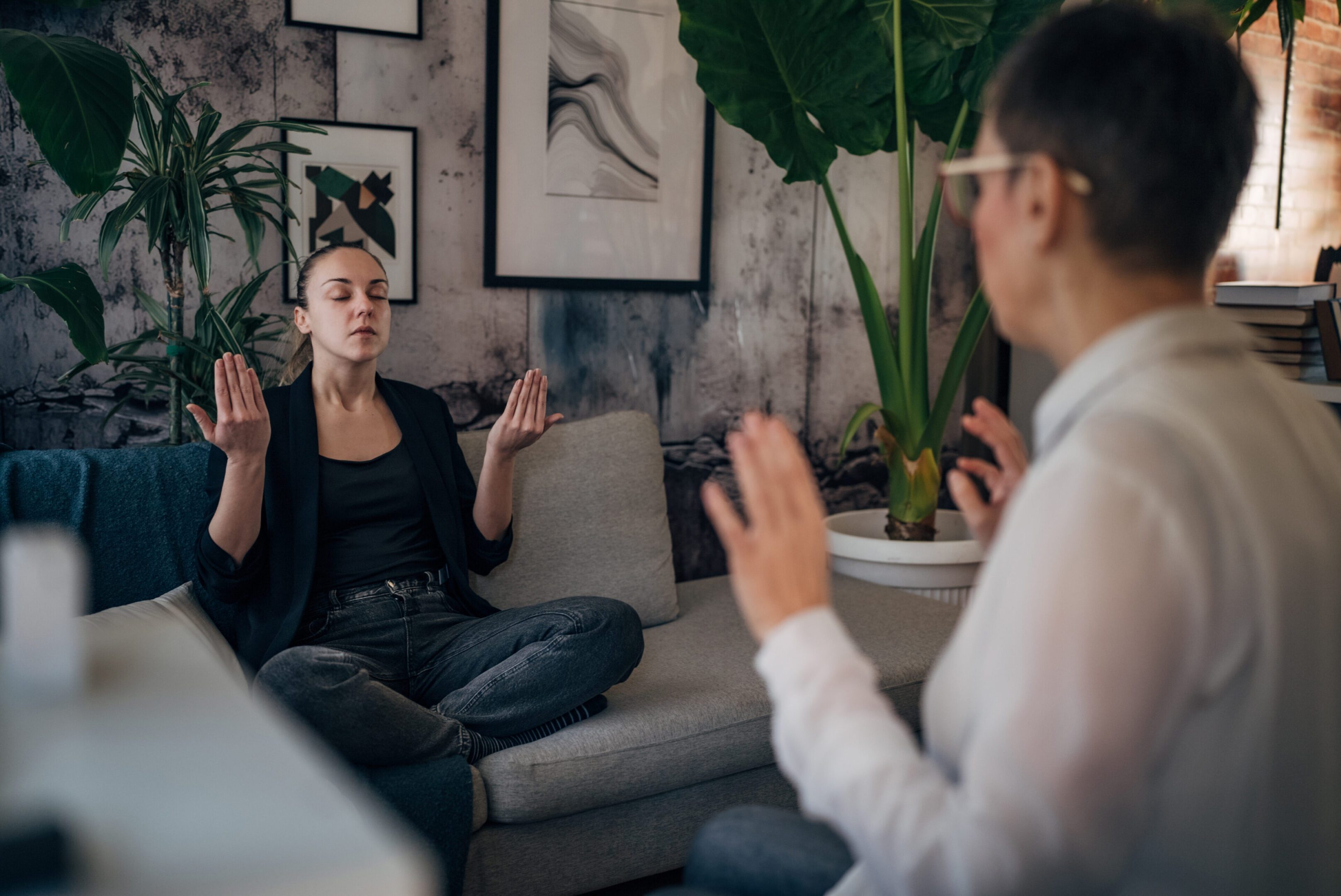 Two people meditating in a peaceful room.