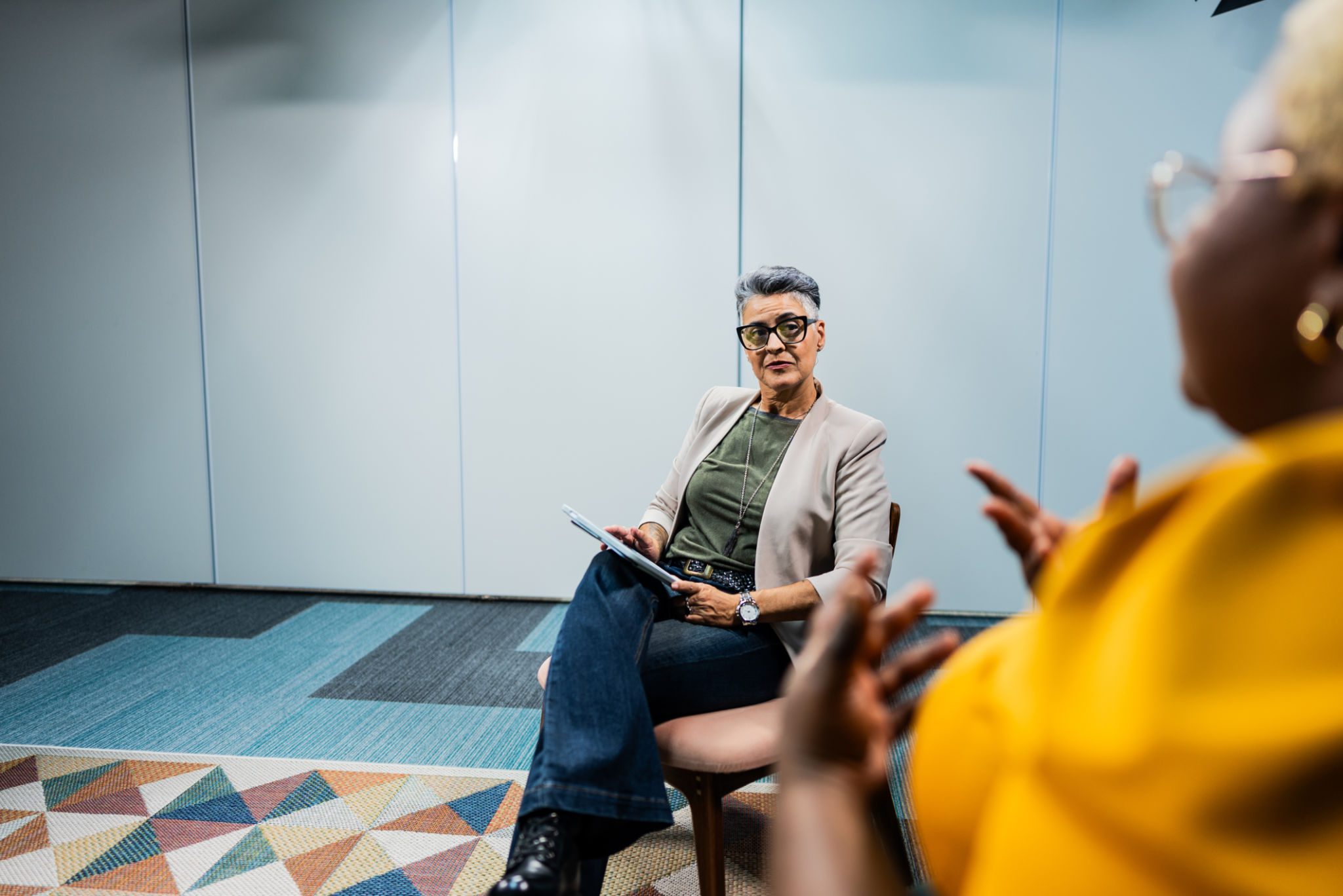 Person in glasses listening attentively