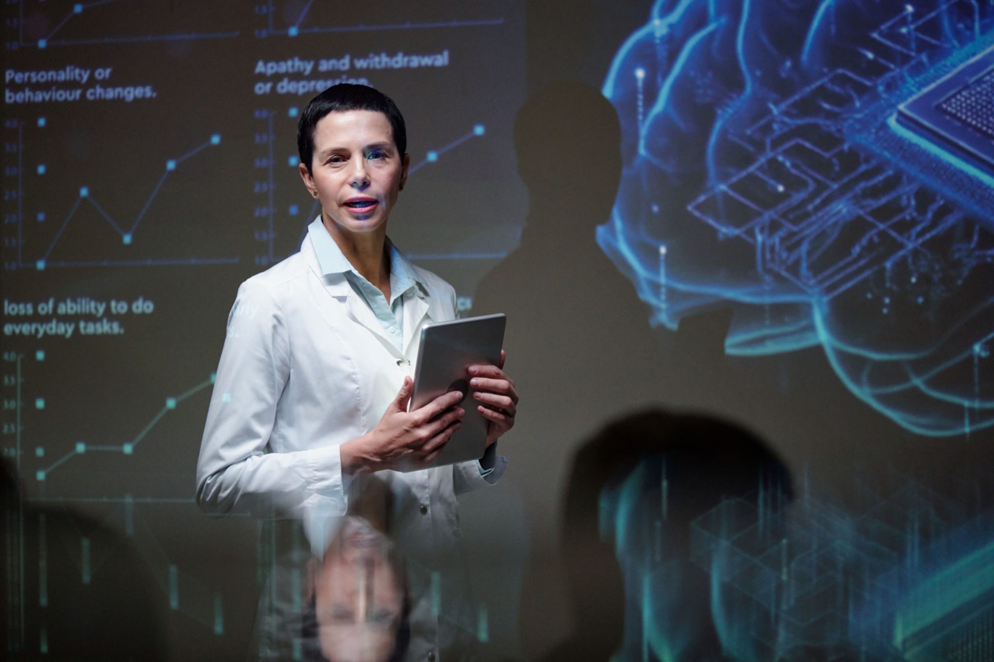 Researcher with tablet and holographic display.